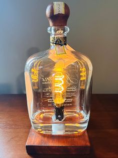 an empty glass bottle sitting on top of a wooden table