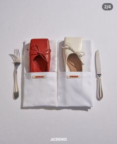 two pairs of shoes sitting on top of napkins next to silverware and utensils