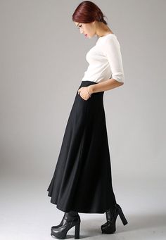 "Look elegant and stylish at all times and for any occasion in this long black classical A-line skirt. This flared women skirt with double stitching detail at hip pockets oozes understated sophistication. This very versatile winter skirt can be worn casually with knitwear or more formally with a crisp white blouse.This is a timeless investment piece you'll have in your wardrobe for years to come. Choosing black makes it so easy to pair with a variety of blouses and jackets. Scientific studies ha Classic A-line Maxi Skirt For Formal Occasions, Classic Black A-line Skirt, Elegant A-line Bottoms For Winter, Elegant Winter Maxi Skirt, Black A-line Maxi Skirt For Winter, Spring Formal Wool Skirt, Formal Wool Skirt For Spring, Formal Spring Wool Skirt, Classic Black Pleated Maxi Skirt