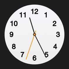 a white clock with orange hands and numbers on the face is showing eleven o'clock