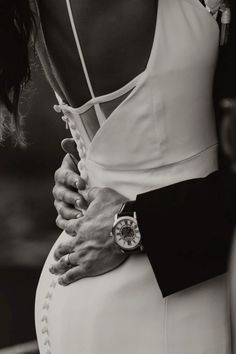 black and white photograph of woman in dress holding hands