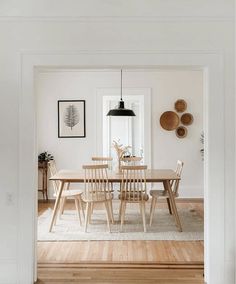 the dining room table is surrounded by wooden chairs