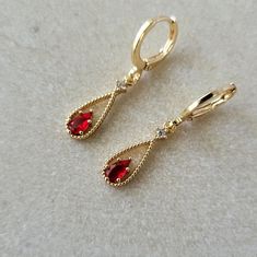 Ruby Red & Crystal Teardrop Teardrop Jewel Huggie Hoop Earrings, 14k Gold Plated Earrings, Vintage Style Earrings, Victorian Earrings Product specifications: * Material: 14K Gold Plated Brass * Size Each charm measures 1.8 cm x 0.6 cm.  Earring Options: * 8mm inner diameter lever back hoops (1.1cm outer diameter, 1.5cm drop) * 10mm inner diameter lever back hoops (1.3cm outer diameter, 1.6cm drop) Packaging and Gifts: * All pieces of jewellery are set on a card in a mesh jewellery pouch  Shippin Elegant Red Huggie Hoop Earrings, Valentine's Day Teardrop Earrings, Red Huggie Earrings For Anniversary, Red Teardrop Hoop Earrings, Red Teardrop Hoop Earrings For Pierced Ears, Red Hypoallergenic Dangle Hoop Earrings, Red Teardrop Hoop Earrings With Ear Wire, Vintage Earrings Victorian, October Jewelry