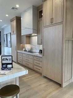 a laptop computer sitting on top of a kitchen counter