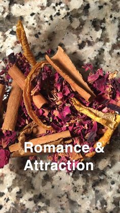 the words romance & attraction surrounded by cinnamons and cloves on a marble surface