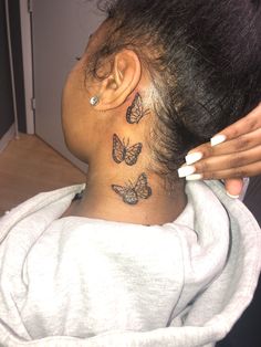 a woman with a butterfly tattoo on her neck