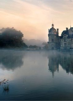 a large building sitting on top of a lake