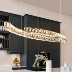 a kitchen with a large chandelier hanging from the ceiling