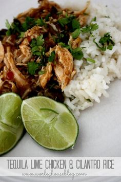 chicken and cilantro rice with lime wedges on a white plate for garnish