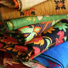 a stack of colorful cloths sitting next to each other on top of a table