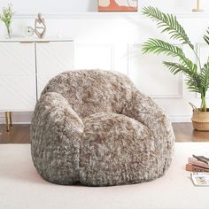 a large bean bag chair sitting on top of a white rug in a living room