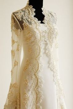 a white dress with gold lace on the shoulders and sleeves, is displayed in an instagram