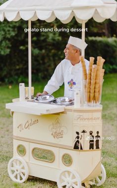 a man standing behind an ice cream cart