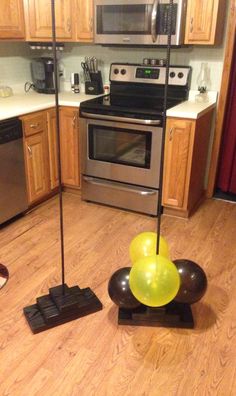 a kitchen with an oven, stove and balloons on the floor in front of it