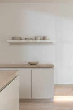 a bowl on a counter in a white kitchen