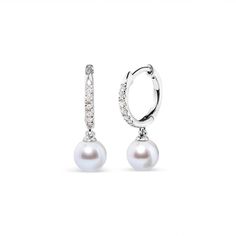 Introducing a captivating masterpiece for women who seek elegance and sophistication. These exquisite pearl drop earrings feature a dazzling array of 12 round diamonds accented. The diamonds, sourced from nature, boast a brilliant H-I color and are set in a mesmerizing pave setting. The I1-I2 clarity adds a unique allure to these earrings. The lustrous white freshwater-cultured pearls, sourced from Chinese freshwater, are beautifully showcased in a cup setting. With a medium-luster and AAA+ grade, these 6.0mm round pearls exude timeless beauty. Crafted with attention to detail, these earrings are designed for women who appreciate the finest things in life. Completed with lever-back findings, these earrings ensure a secure and comfortable fit. Indulge yourself or surprise a loved one with t Huggy Earrings, White Gold Earrings, Pave Setting, Freshwater Cultured Pearls, Pearl Drop Earrings, Pearl Drop, Cultured Pearls, Timeless Beauty, Fresh Water