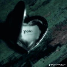 a heart shaped object with the word you written on it's side, in black and white