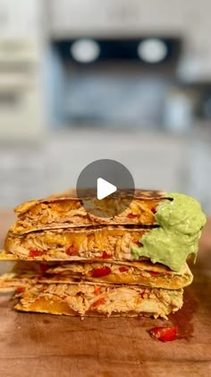 a stack of quesadillas with guacamole on the top and bottom