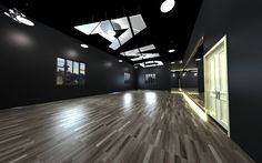 an empty room with wood flooring and black walls is lit by recessed lights