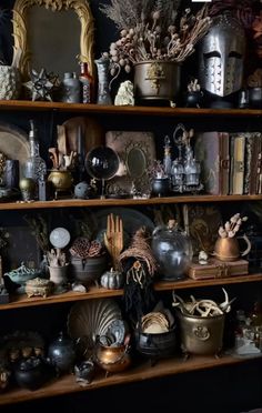 a shelf filled with lots of different types of vases and other things on top of it