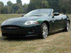 a green sports car parked in the grass