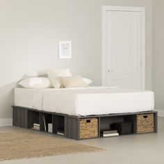 a bed with two drawers underneath it in a room next to a rug and door