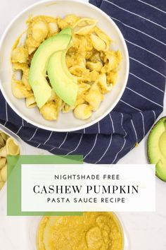 a bowl of cashew pumpkin pasta with avocado on the side and an avocado slice next to it