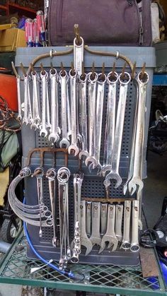 a bunch of wrenches are hanging on a rack