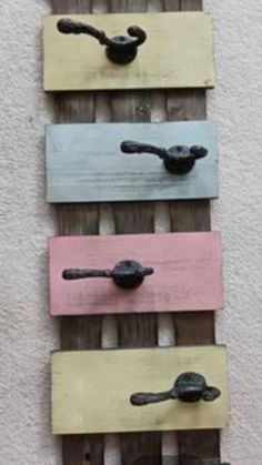 four wooden hooks are hanging on the wall