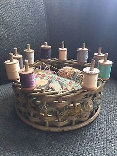 several spools of thread are sitting in a basket