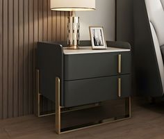 a nightstand with a lamp on it next to a bed