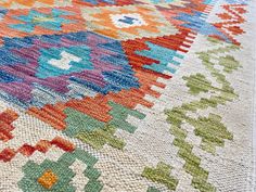 a multicolored rug with many different designs on it