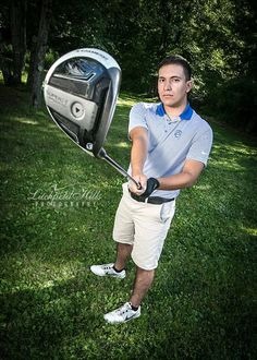 a man holding a golf club in his right hand