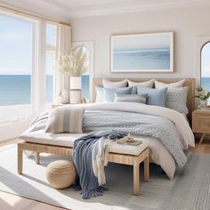 a bedroom with a large window overlooking the ocean