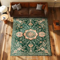 an overhead view of a living room with a couch and rug on the hardwood floor