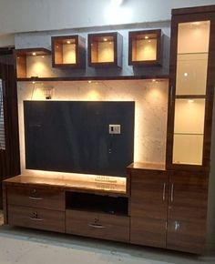 a large entertainment center with cabinets and lights