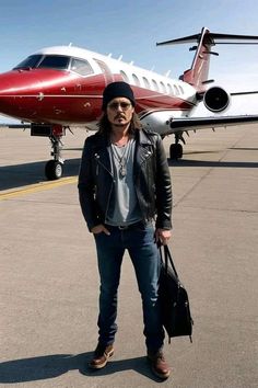 a man is standing in front of an airplane on the tarmac with his luggage