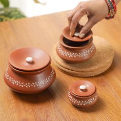 "These Floral Ceramic Serving Bowls with Lid are perfect for your next dinner party or potluck. Its perfect for storing and serving curries, Biriyani, Dahi, Curd, etc. Also you can store pickles, Its a great decor for your dining table. Its traditional design and intricate detailing will make it a hit with your guests. It comes in 3 sizes - small, medium and large - so you can customize your meal according to your needs. Made from quality ceramic, these bowls are highly durable and dishwasher-safe.   𝐒𝐢𝐳𝐞 : Small :1.5\" (H) * 3.5\" (W) Medium :2.7\" (H) * 4.5\" (W) Large:4\" (H) * 6\" (W) 𝐂𝐚𝐩𝐚𝐜𝐢𝐭𝐲 : Small :110ml Medium: 360 ml Large:700ml Extra large: 900ml 𝐂𝐨𝐥𝐨𝐫: Brown 𝐌𝐚𝐭𝐞𝐫𝐢𝐚𝐥 : Ceramic 𝐐𝐮𝐚𝐧𝐭𝐢𝐭𝐲: 1 pc 𝐂𝐡𝐞𝐜𝐤 𝐨𝐮𝐭 𝐨𝐮𝐫 𝐦𝐨𝐫𝐞 𝐜𝐞𝐫𝐚𝐦𝐢𝐜 𝐩𝐫? Indian Housewarming, Housewarming Return Gifts, Black Dessert, Wooden Serving Platters, Serving Bowls With Lids, Crockery Design, Ceramic Serving Bowl, Grad Party Decorations, Indian Pottery