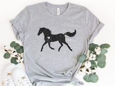 If you or someone you know is a horse lover or owns a horse, the Horse Shirt is the perfect gift for them! The Horse Shirt has an all-over print of kids riding horses on a light-blue background. It is designed to be loose fitting. This is an adorable shirt that makes the perfect gift for any horse lover or owner! This comfortable t-shirt will be your and your friends' favorite! Be simple, be different! M A T E R I A L S → All our simple color ones like White and Black are 100% Cotton. → All our Kids Riding Horses, Horse Trainer Gifts, Funny Baking Shirts, Horse T Shirt, Equestrian Shirt, Farmer Shirt, Church Shirt, Glitter Shirt, Horse Shirt