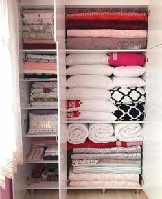 the closet is filled with many different types of folded towels and other things in it