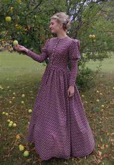 This charming dress has a jewel neckline, front button closure and leg-o-mutton long sleeves. The fitted bodice has a full skirt gathered at the waist. This dress also features our three-paneled full skirt with pockets. Hand wash or machine wash and dry gently. 100% sturdy cotton. The model is wearing boots and a crinoline, which are priced separately. Designed and made proudly by Recollections in America! The following are approximate finished measurements and include room for ease of movement. Little House On The Prairie Dress, Prarie Dresses, Grandma Dress, Pioneer Clothing, Pioneer Dress, Colonial Dress, Vintage Prairie Dress, Farm Dress, Grandma Fashion