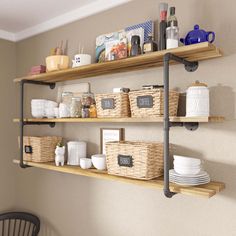 two shelves with baskets, plates and cups on them in front of a dining room table