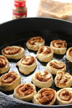 some cinnamon rolls are cooking in a skillet