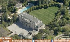 an aerial view of a large mansion in the woods