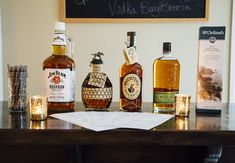 several different types of liquor sitting on a table