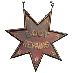 an old rusty star sign with the words boot repairs hanging from it's side