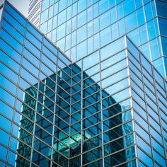 the reflection of skyscrapers in glass windows