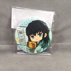 a badge with an anime character holding a bowl of food in it's hand