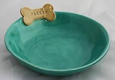 a green bowl with a dog bone and name on the side that says parker