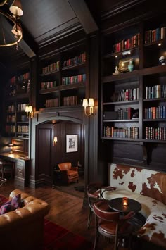 a living room filled with lots of furniture and bookshelves covered in bookcases